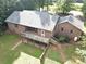 Aerial view of a brick home with a wooden deck and green lawn at 169 Wilcox Karriker Ln, Statesville, NC 28625