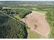 Aerial view showcasing the expansive property with a mix of wooded areas and open fields at 169 Wilcox Karriker Ln, Statesville, NC 28625