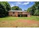 View of a brick home with a large back deck and expansive yard at 169 Wilcox Karriker Ln, Statesville, NC 28625