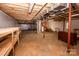 Unfinished basement featuring exposed beams and a water heater at 169 Wilcox Karriker Ln, Statesville, NC 28625