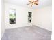 A carpeted bedroom with two windows and a ceiling fan at 169 Wilcox Karriker Ln, Statesville, NC 28625