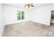 Spacious bedroom featuring neutral carpet, a ceiling fan and a large window with backyard views at 169 Wilcox Karriker Ln, Statesville, NC 28625