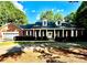 Inviting brick home featuring a covered front porch, dormer windows, and attached garage at 169 Wilcox Karriker Ln, Statesville, NC 28625