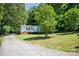 Exterior view of charming single-story home with a welcoming front porch and driveway at 169 Wilcox Karriker Ln, Statesville, NC 28625