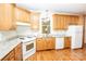 Functional kitchen featuring wood cabinets, laminate countertops, and matching white appliances at 169 Wilcox Karriker Ln, Statesville, NC 28625