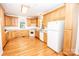 Bright kitchen featuring wood cabinets, white appliances, and a window offering natural light at 169 Wilcox Karriker Ln, Statesville, NC 28625