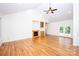 Bright living room boasting hardwood floors, high vaulted ceiling, and fireplace with built-in shelving at 169 Wilcox Karriker Ln, Statesville, NC 28625
