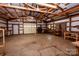 Interior outbuilding view shows open space and large roll-up door at 169 Wilcox Karriker Ln, Statesville, NC 28625