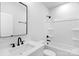 Bathroom with modern fixtures, a tub, a white sink with a dark faucet, and vanity mirror at 2104 County Line Rd, Kings Mountain, NC 28086