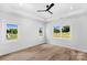 Spacious bedroom with hardwood floors, tray ceiling with fan, and lots of natural light from multiple windows at 2104 County Line Rd, Kings Mountain, NC 28086