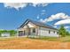 Charming home with white siding, black roof, and inviting front porch with wooden columns at 2104 County Line Rd, Kings Mountain, NC 28086