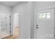 Bright hallway featuring white door, wood floors, leading into a bathroom at 2104 County Line Rd, Kings Mountain, NC 28086