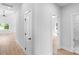 Hallway featuring hardwood flooring, white walls, and doors leading to different rooms at 2104 County Line Rd, Kings Mountain, NC 28086