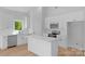 Modern kitchen featuring stainless appliances, white cabinets, and an island with a quartz countertop at 2104 County Line Rd, Kings Mountain, NC 28086