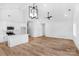 Open living room and kitchen area featuring stylish lighting, vaulted ceilings, and stainless appliances at 2104 County Line Rd, Kings Mountain, NC 28086