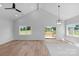 Open-concept living area with hardwood floors, modern lighting, and sliding doors to the outdoor deck at 2104 County Line Rd, Kings Mountain, NC 28086