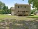 Exterior rear of the home with a deck and a spacious lawn at 2240 Lawton Bluff Rd, Charlotte, NC 28226