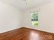 Bright bedroom with hardwood floors and large window overlooking the front yard at 2240 Lawton Bluff Rd, Charlotte, NC 28226
