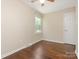 Bedroom featuring hardwood floors and a single window with a white door and hardware at 2240 Lawton Bluff Rd, Charlotte, NC 28226