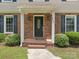 Close-up of the front door with brick accents and detailed trim at 2240 Lawton Bluff Rd, Charlotte, NC 28226