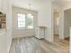 Kitchen nook with breakfast bar, lots of light from 2 windows, and wood-look tile flooring at 2240 Lawton Bluff Rd, Charlotte, NC 28226