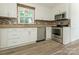 Charming kitchen with white cabinets, stainless steel appliances, and wood-look tile flooring at 2240 Lawton Bluff Rd, Charlotte, NC 28226