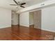Bright living area with hardwood floors, ceiling fan, and sliding barn door at 2240 Lawton Bluff Rd, Charlotte, NC 28226