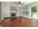 Spacious living room featuring a stone fireplace, large window, and access to the deck at 2240 Lawton Bluff Rd, Charlotte, NC 28226