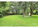 A spacious, green backyard with mature trees, providing shade and privacy at 2421 Shamrock Dr, Charlotte, NC 28205