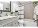 Well-lit bathroom featuring a combination shower and tub, tiled walls, and modern fixtures at 2421 Shamrock Dr, Charlotte, NC 28205
