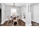 Charming dining area with a modern light fixture and seating for four at 2421 Shamrock Dr, Charlotte, NC 28205
