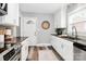 Bright kitchen with white cabinets, stainless steel appliances, and modern countertops at 2421 Shamrock Dr, Charlotte, NC 28205