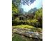 Angle view of brick home with stone accents and lots of surrounding foliage at 2505 White Thorne Ln, Waxhaw, NC 28173