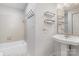 Clean bathroom featuring a pedestal sink, bathtub, and shower with tile surround at 2512 Cranbrook Ln # 9, Charlotte, NC 28207