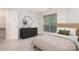 Staged bedroom with neutral colors, a large window with blinds, and a modern dresser at 2512 Cranbrook Ln # 9, Charlotte, NC 28207