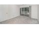 Cozy bedroom with neutral carpeting and a sliding glass door to the outside patio at 2512 Cranbrook Ln # 9, Charlotte, NC 28207
