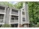 Charming condo featuring balconies and large windows, nestled among lush green trees, offering serene living at 2512 Cranbrook Ln # 9, Charlotte, NC 28207