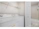 A convenient laundry room with washer, dryer, and access to a full bathroom at 2512 Cranbrook Ln # 9, Charlotte, NC 28207