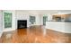 Bright living room featuring gleaming hardwood floors, fireplace, and a seamless transition to the modern kitchen at 2512 Cranbrook Ln # 9, Charlotte, NC 28207