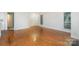 Open-concept living room with hardwood floors, neutral paint, and a large window for natural light at 2512 Cranbrook Ln # 9, Charlotte, NC 28207