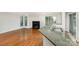 Living room view showcasing hardwood floors, fireplace, and an eat-in kitchen with stone countertops at 2512 Cranbrook Ln # 9, Charlotte, NC 28207