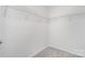 Bright walk-in closet features neutral gray carpet and white wire shelving for optimal storage solutions at 2512 Cranbrook Ln # 9, Charlotte, NC 28207