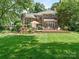 Expansive backyard features a stone patio, outdoor kitchen, and manicured lawn at 2516 Selwyn Ave, Charlotte, NC 28209