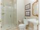 Bathroom with a glass-enclosed shower, pedestal sink, and classic fixtures at 2516 Selwyn Ave, Charlotte, NC 28209
