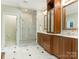 Bathroom featuring a glass enclosed shower, double vanity, and marble floors offering luxury at 2516 Selwyn Ave, Charlotte, NC 28209