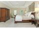 Spacious bedroom with natural light, tray ceiling, and antique armoire creates a peaceful retreat at 2516 Selwyn Ave, Charlotte, NC 28209
