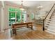 Sunlit dining room with a large window, hardwood floors, and open access to the kitchen at 2516 Selwyn Ave, Charlotte, NC 28209