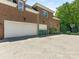 Exterior view of brick home with a spacious driveway and three-car garage at 2516 Selwyn Ave, Charlotte, NC 28209