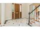 Foyer features marble floors, a wood door with sidelights and a staircase with white and black trim at 2516 Selwyn Ave, Charlotte, NC 28209
