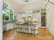 Bright, airy kitchen featuring custom cabinets, bar seating, stainless steel appliances and hardwood floors at 2516 Selwyn Ave, Charlotte, NC 28209